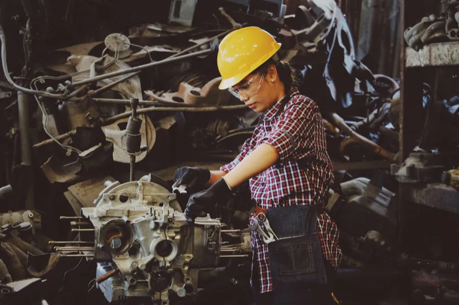 Automotive technician working on an engine